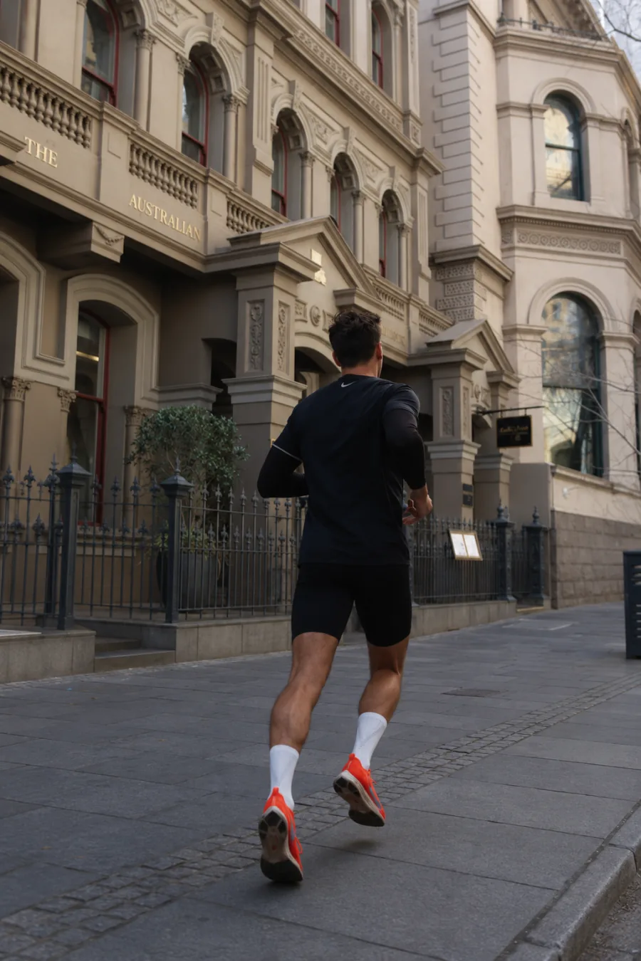 Man running outside 80 Collins Street near Pride Podiatry Melbourne CBD